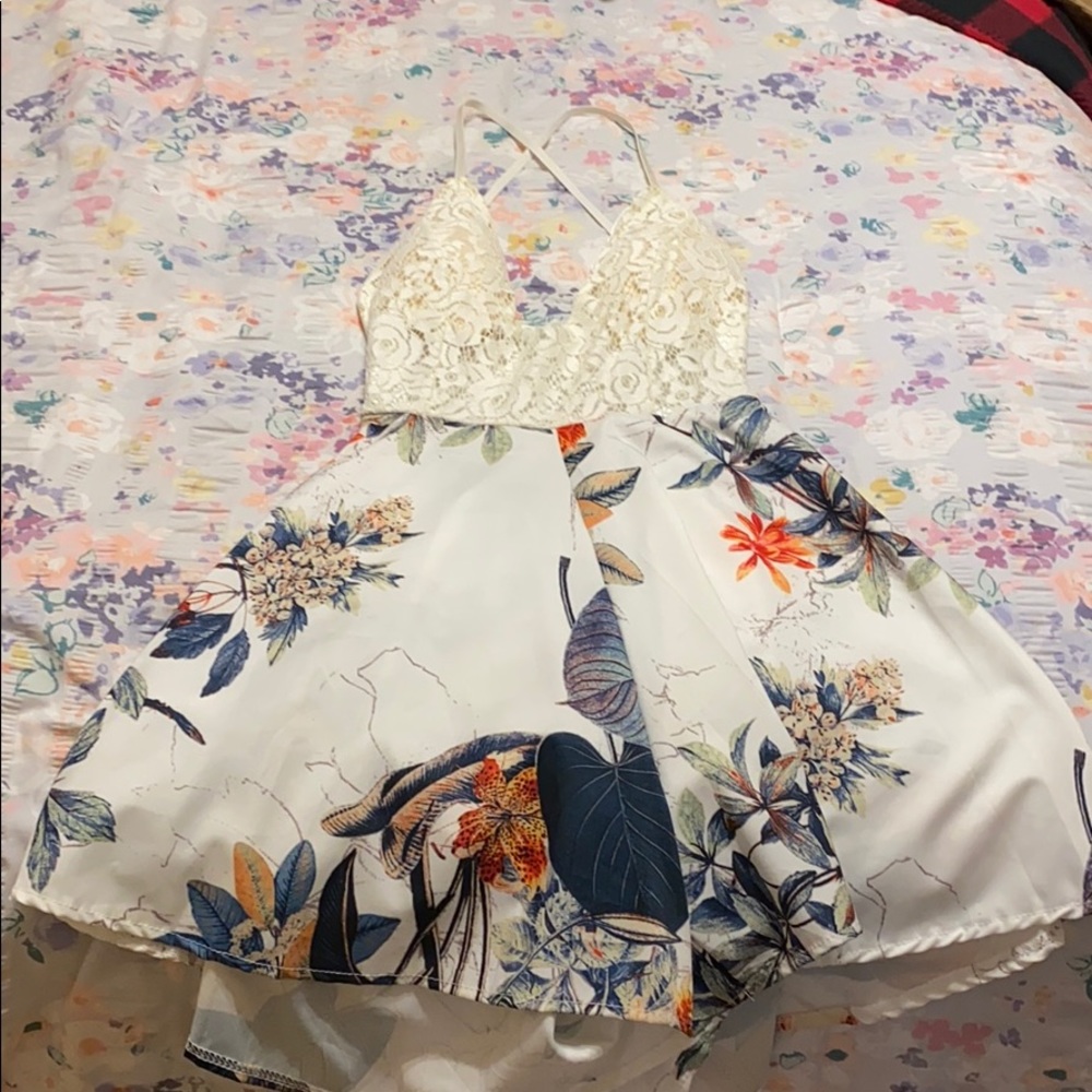 White/ cream top dress with shorts and flowers.